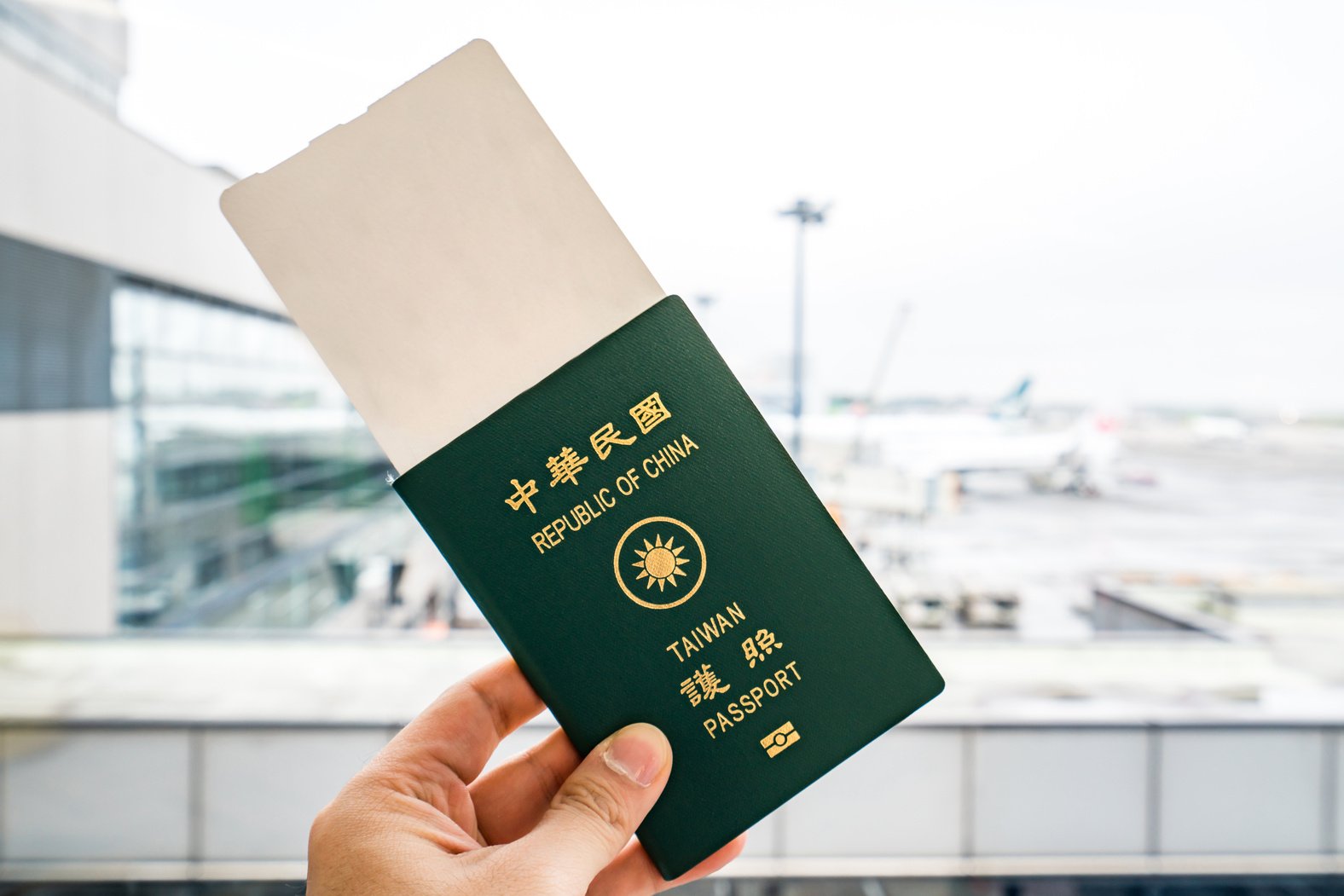 A Person Holding Taiwan Passport and Boarding Pass 